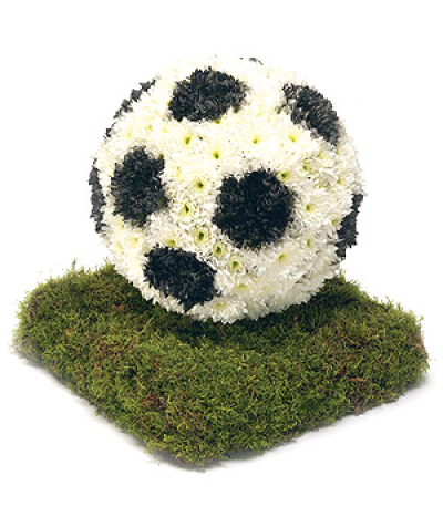 Football - Based Chrysanthemum funeral tribute in the shape of a football on turf.

Our funeral designs are created with care and hand delivered to the funeral directors.