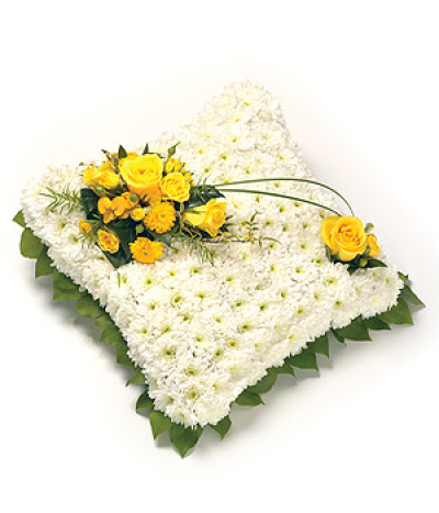 Traditional Cushion - A classic white Chrysanthemum based cushion design with foliage edge, decorated with a spray which includes Roses.

Delivering in Norwich and surrounding areas (please check on our delivery page for areas we cover)

Our funeral designs are created with care and hand delivered to the funeral directors.